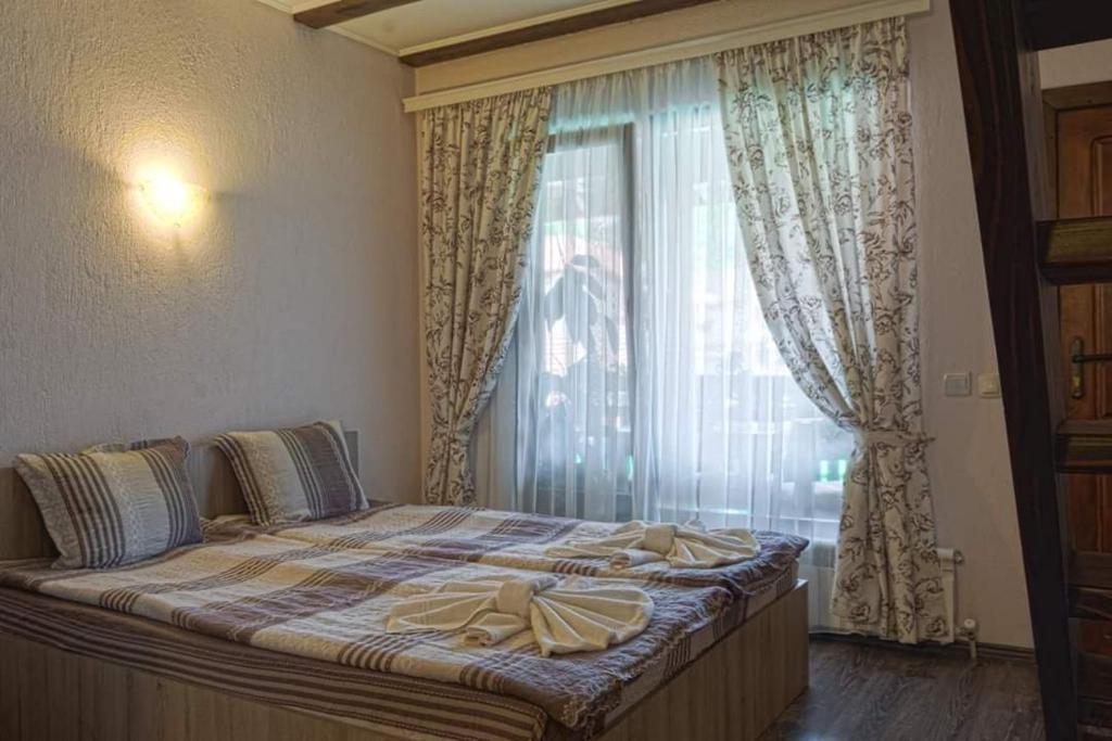 Postel nebo postele na pokoji v ubytování СТАР МЕРАК