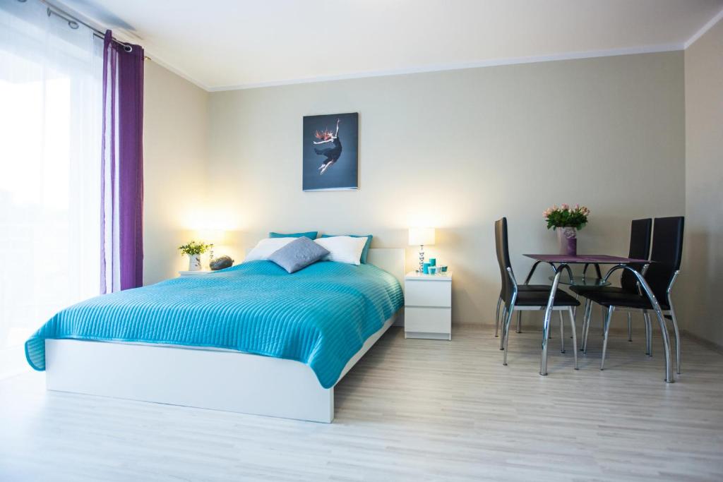 Postel nebo postele na pokoji v ubytování Apartamenty Feniks & Pegaz