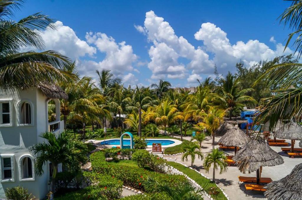 an aerial view of a resort with a pool and palm trees at Hotel Puerto Holbox Beach Front in Holbox Island