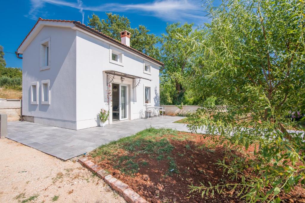 ein weißes Haus mit Auffahrt in der Unterkunft Holiday Home Frankica in Linardići