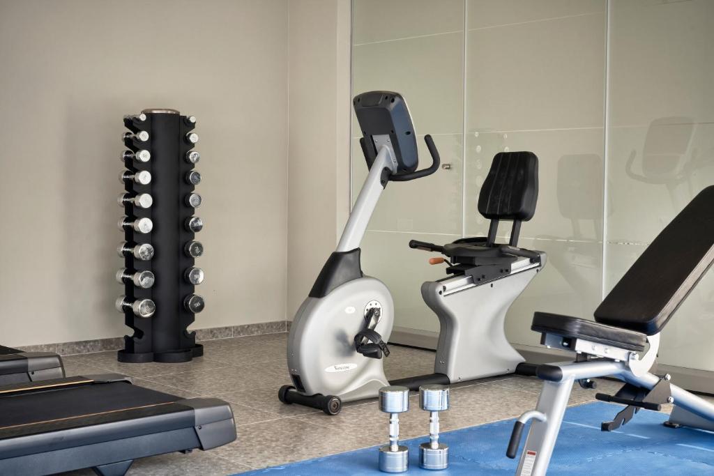 a gym with a treadmill and exercise equipment at Antigoni Seaside Resort in Ormos Panagias
