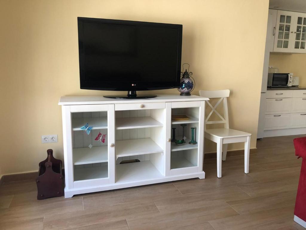 a white entertainment center with a flat screen tv on it at VALHOME in La Nucía