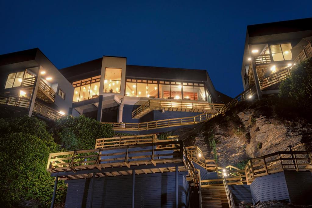 a house on a hill with lights on at Hotel Boutique Puramar in Curanipe