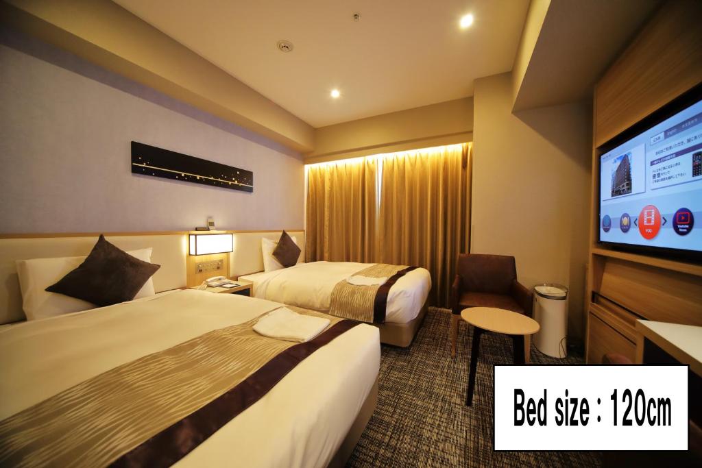 Postel nebo postele na pokoji v ubytování Hotel Sunroute Asakusa