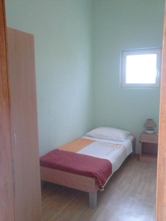 Posteľ alebo postele v izbe v ubytovaní Apartmani Emily