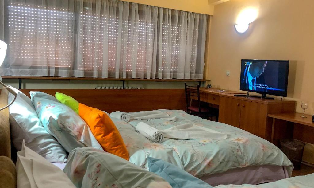 Postel nebo postele na pokoji v ubytování Hotel Square
