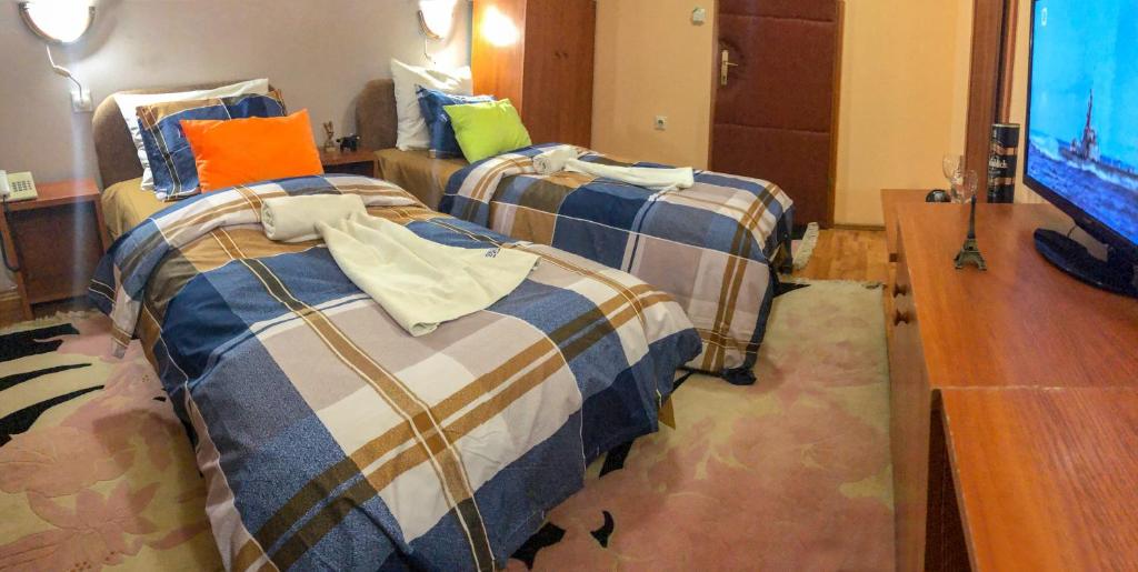 Postel nebo postele na pokoji v ubytování Hotel Square