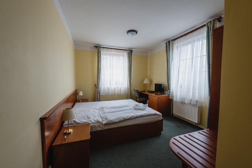 Postel nebo postele na pokoji v ubytování Hotel Taverna