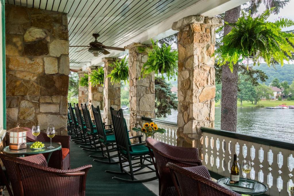 a restaurant with chairs and tables and a view of the water at Lake Pointe Inn in McHenry