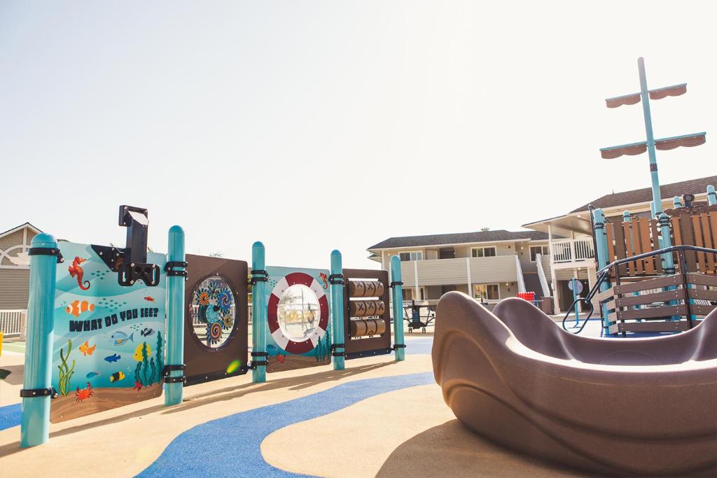 einen Spielplatz mit Rutsche in einem Park in der Unterkunft Pismo Lighthouse Suites in Pismo Beach