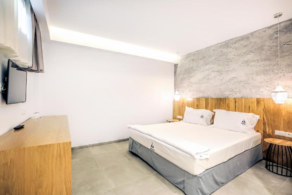 Postel nebo postele na pokoji v ubytování Senso Suites