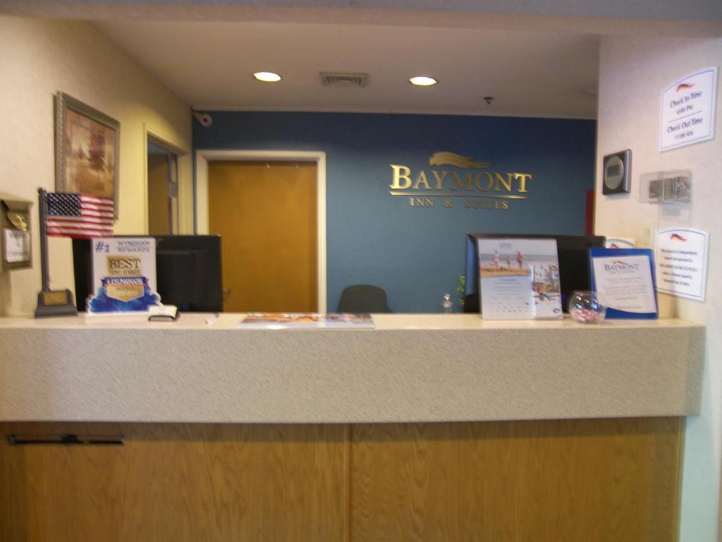 un mostrador de oficina con un letrero que dice Benmont inn y suites en Baymont by Wyndham Mount Vernon Renfro Valley en Mount Vernon