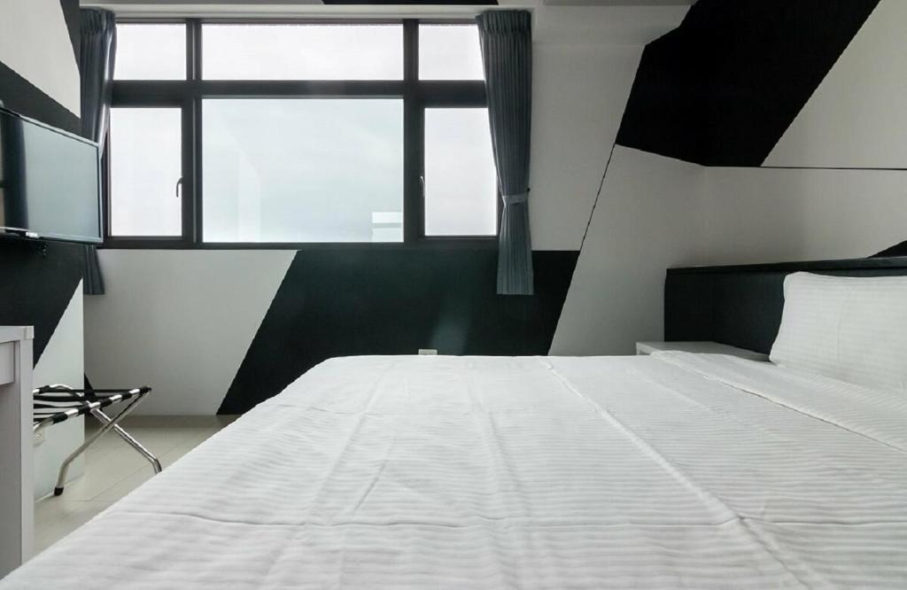 Postel nebo postele na pokoji v ubytování Hualien KeyInn Space