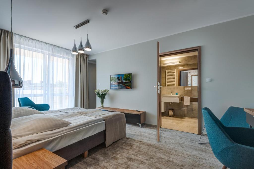 Postel nebo postele na pokoji v ubytování Hotel Zorza
