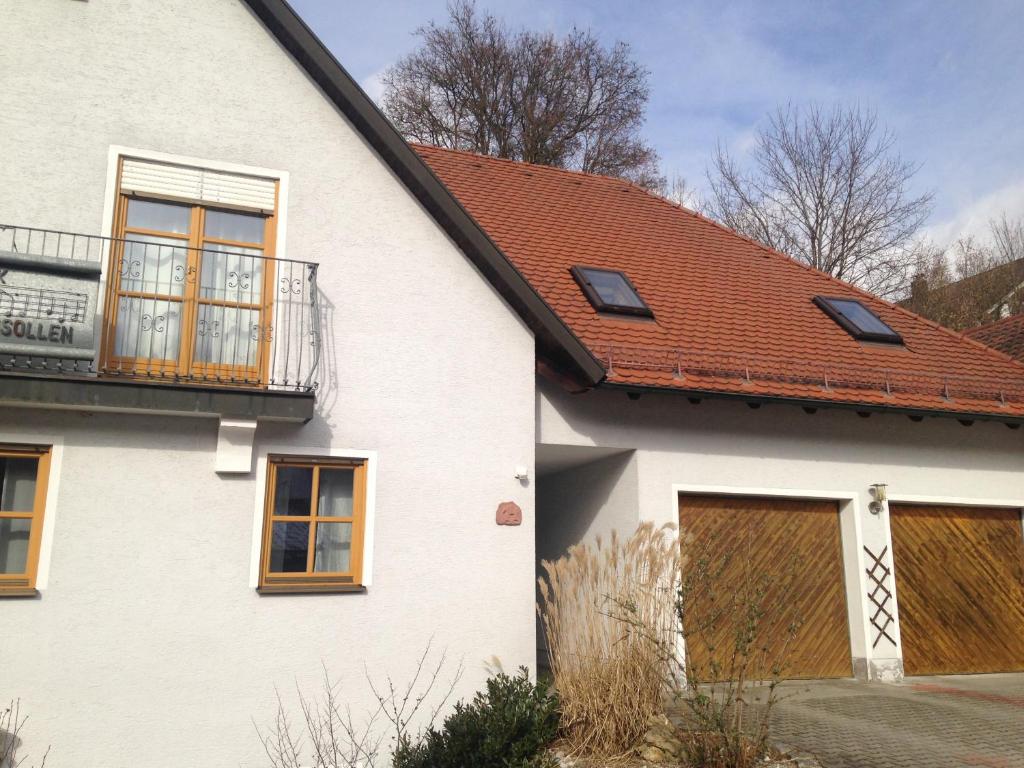 a white house with a brown roof at Ferienwohnung Christina in Ursensollen