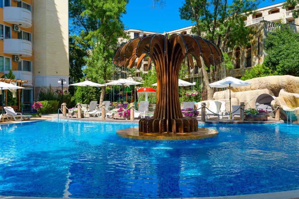 a fountain in the middle of a swimming pool at Sweet Homes Apartments in Sunny Beach