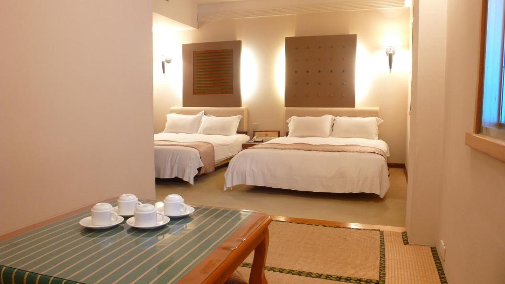 Postel nebo postele na pokoji v ubytování Tian Long Hotel