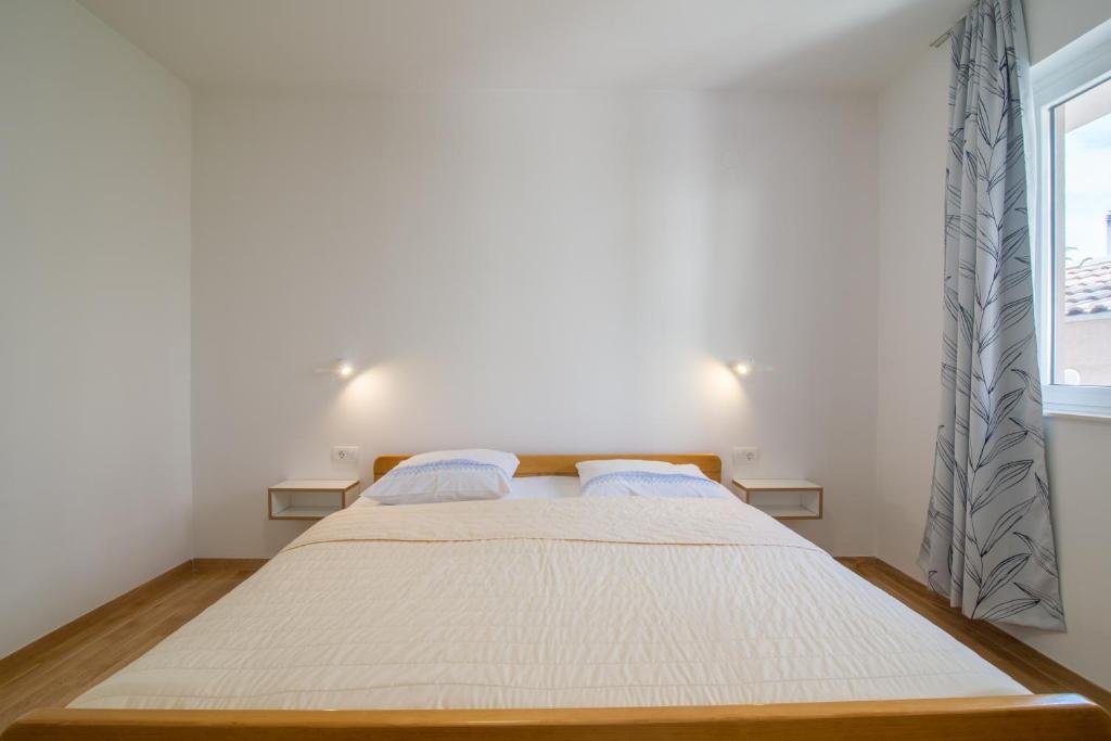 Posteľ alebo postele v izbe v ubytovaní Apartmani Drago