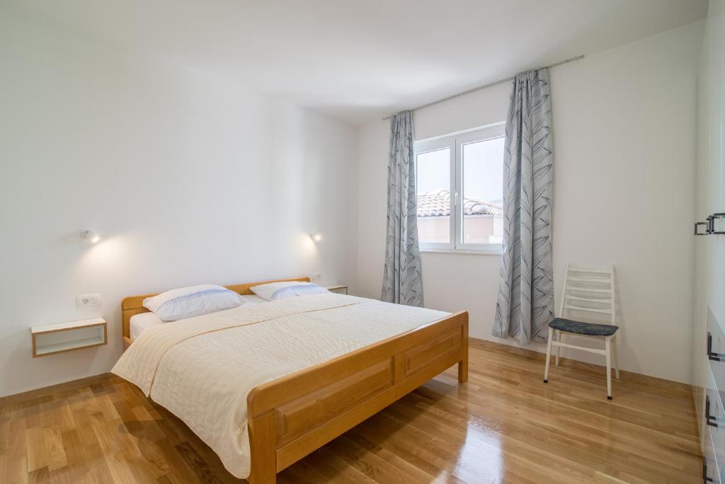 Posteľ alebo postele v izbe v ubytovaní Apartmani Drago