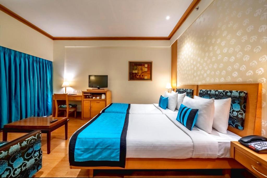 Postel nebo postele na pokoji v ubytování Kenilworth Hotel, Kolkata