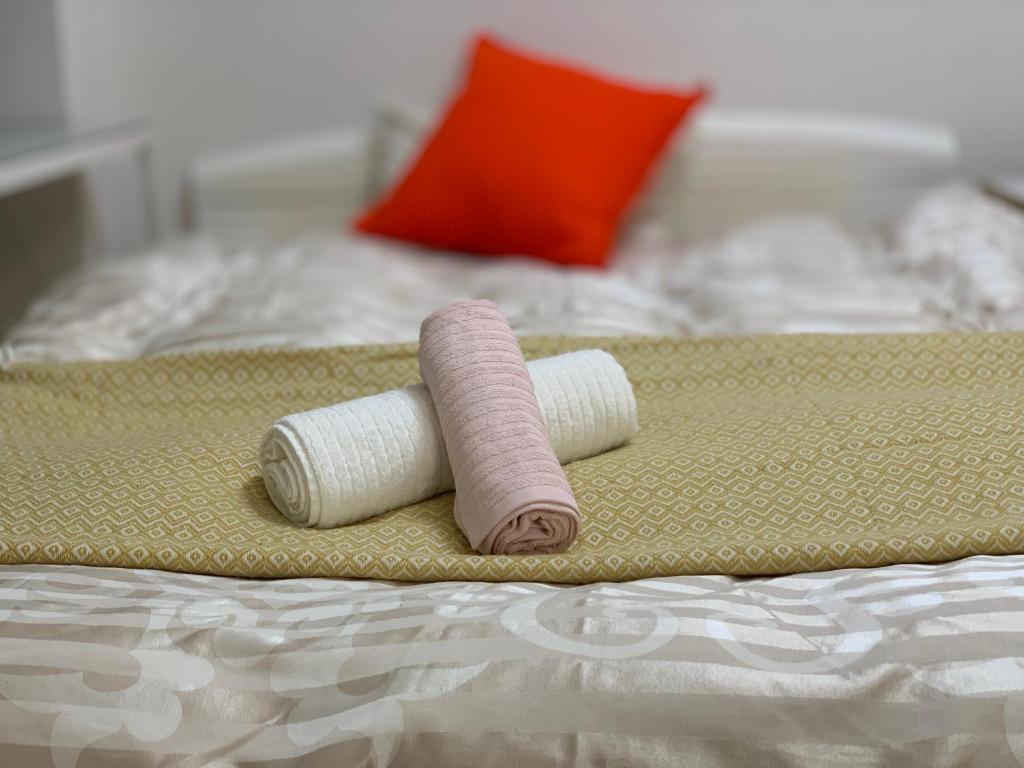 three rolls of thread sitting on a bed at GOLDHOUSE Shinosaka 303 in Osaka