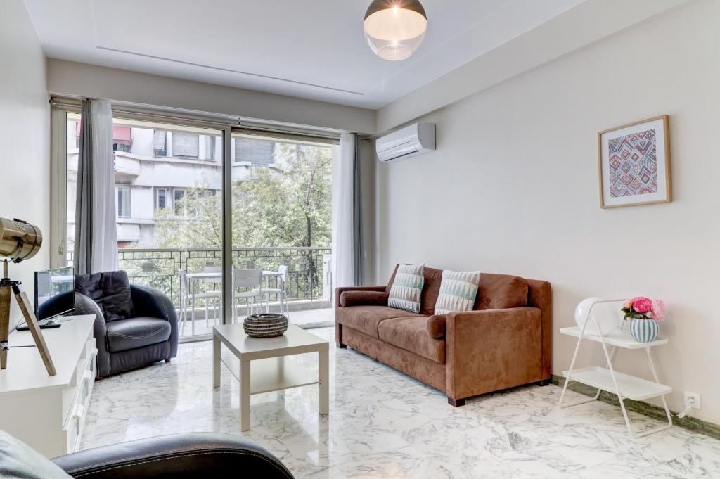 un salon avec un canapé et une table dans l'établissement PROMENADE HOLIDAY - PALATIN PROMENADE, à Nice