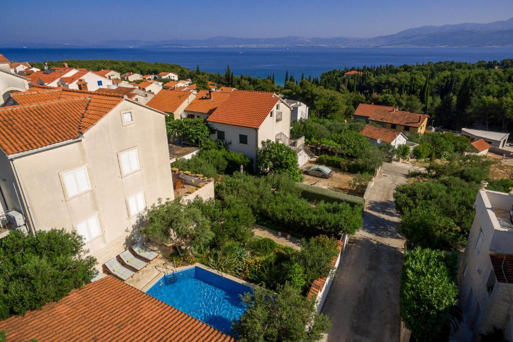 an aerial view of a house with a swimming pool at Villa Lukrecia - Stone Villa with Pool & Sea Views I Supetar, Brač in Supetar