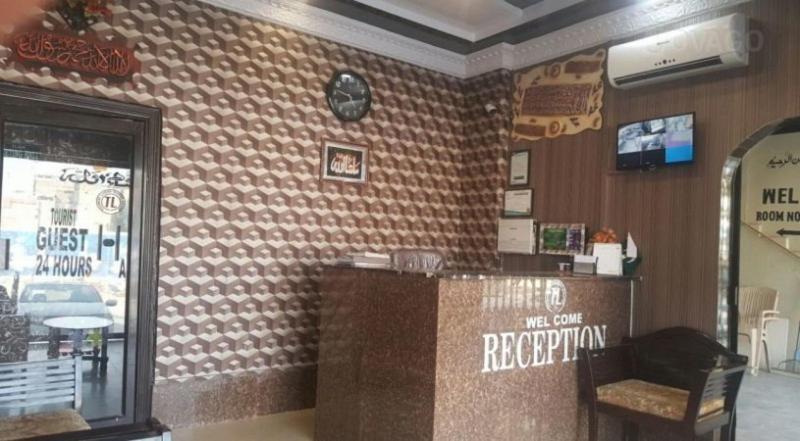 a fast food restaurant with a counter in a room at Tourist Lodge Guest House in Kalar Goth