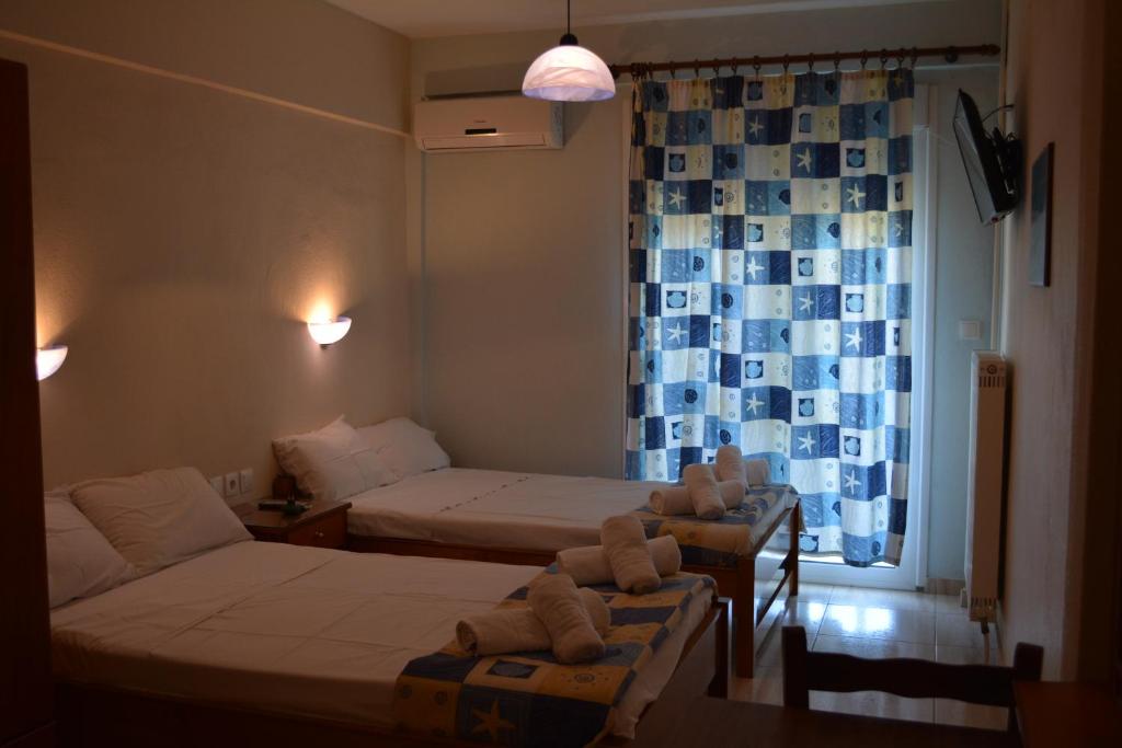 Postel nebo postele na pokoji v ubytování GLIKERIA ROOMS