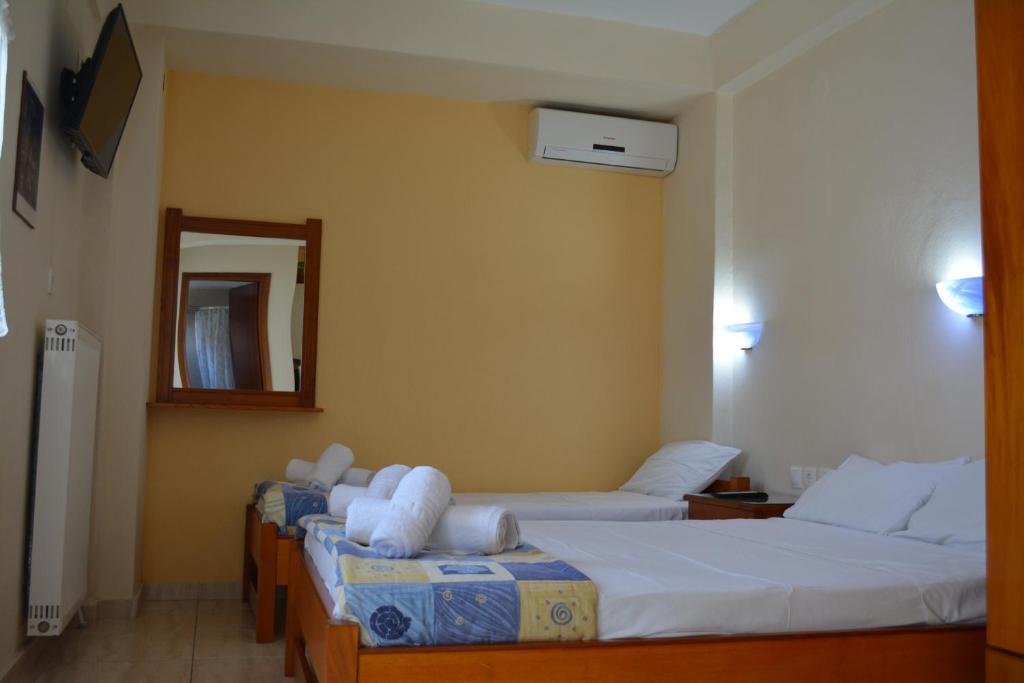 Postel nebo postele na pokoji v ubytování GLIKERIA ROOMS