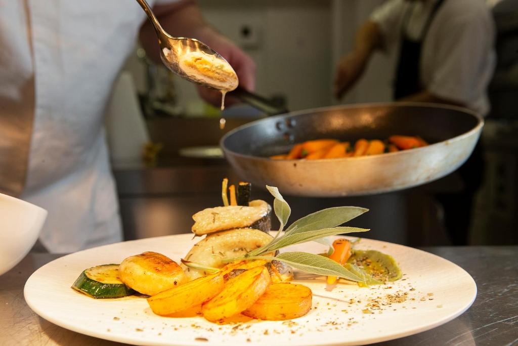 a plate of food on a table in a kitchen at Luxury Hotel Riva in Malinska