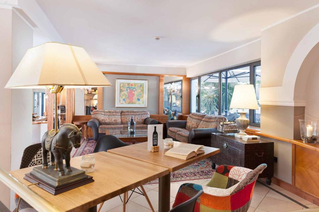 a living room with a table with a lion statue on it at Hotel Leon d'Oro in Rovereto