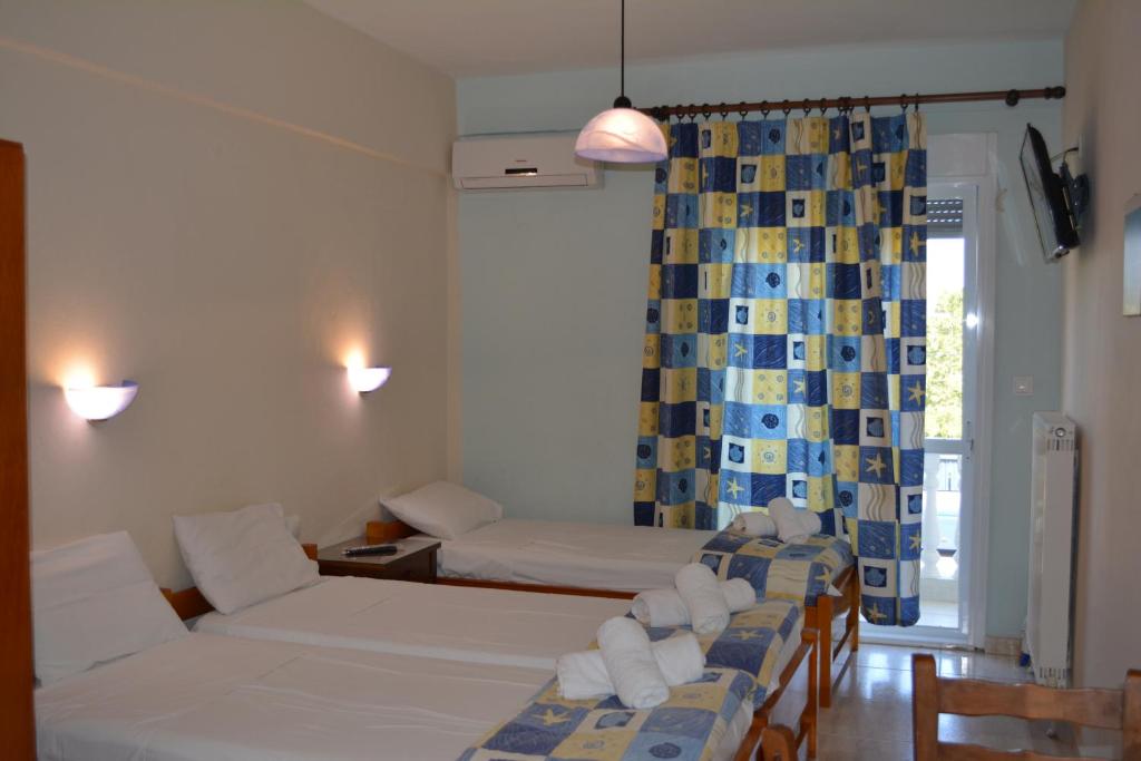 Postel nebo postele na pokoji v ubytování GLIKERIA ROOMS