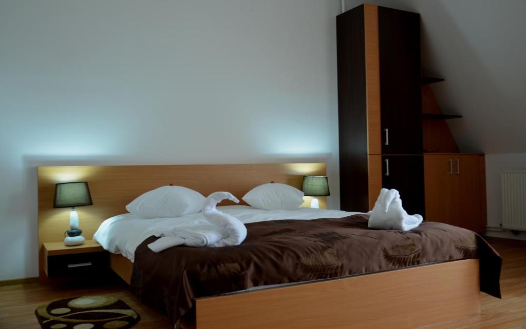 Postel nebo postele na pokoji v ubytování ApartHotel Zorilor