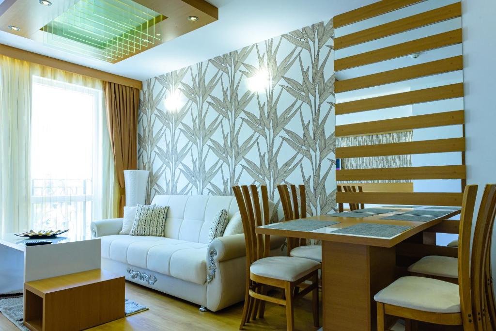 a living room with a couch and a table at Sweet Homes Apartments in Sunny Beach