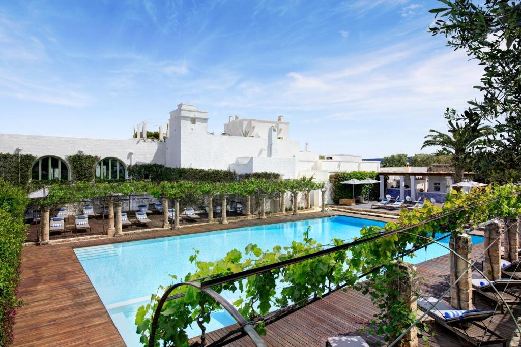 a view of the pool from the balcony of a hotel at Rocco Forte Masseria Torre Maizza in Savelletri di Fasano