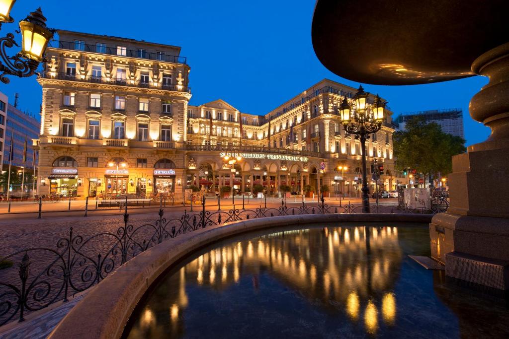 a building with a fountain in front of a building at Steigenberger Icon Frankfurter Hof in Frankfurt