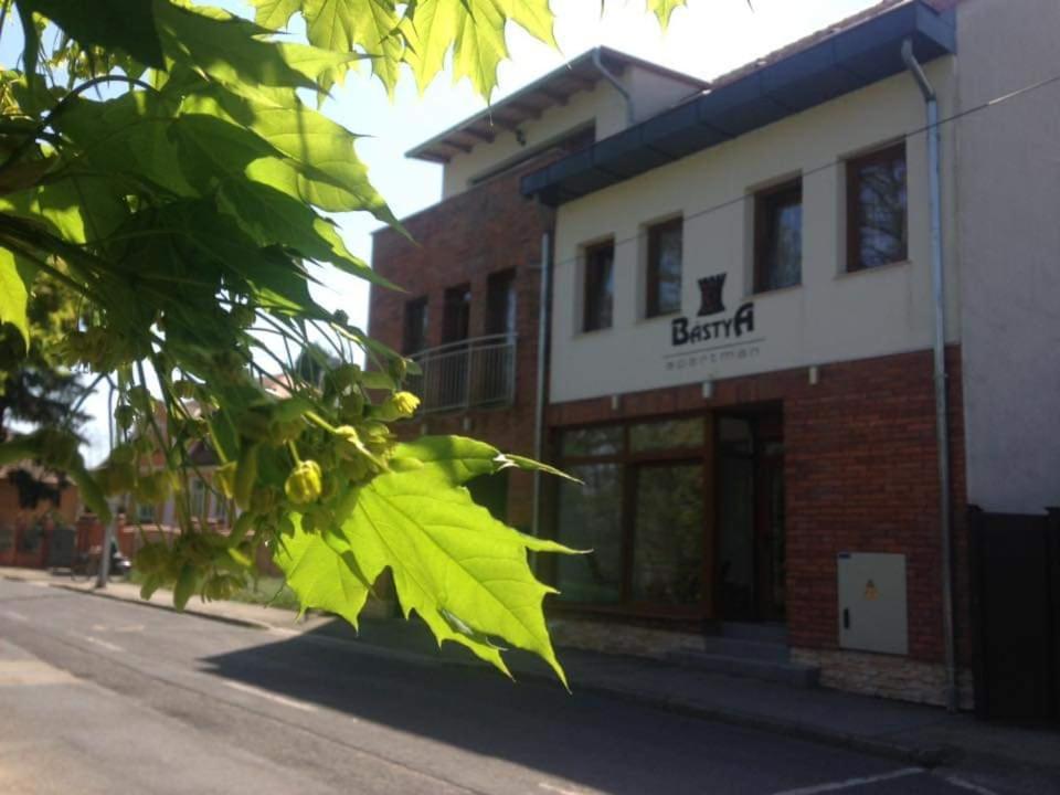 a branch of a building on the side of a street at Bástya Apartmanház in Sárvár