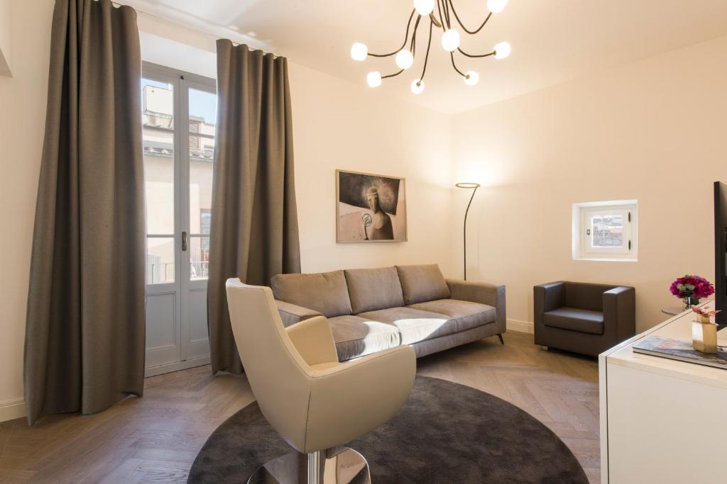 a living room with a couch and a chair at Apartments Florence - Duomo Contemporary in Florence