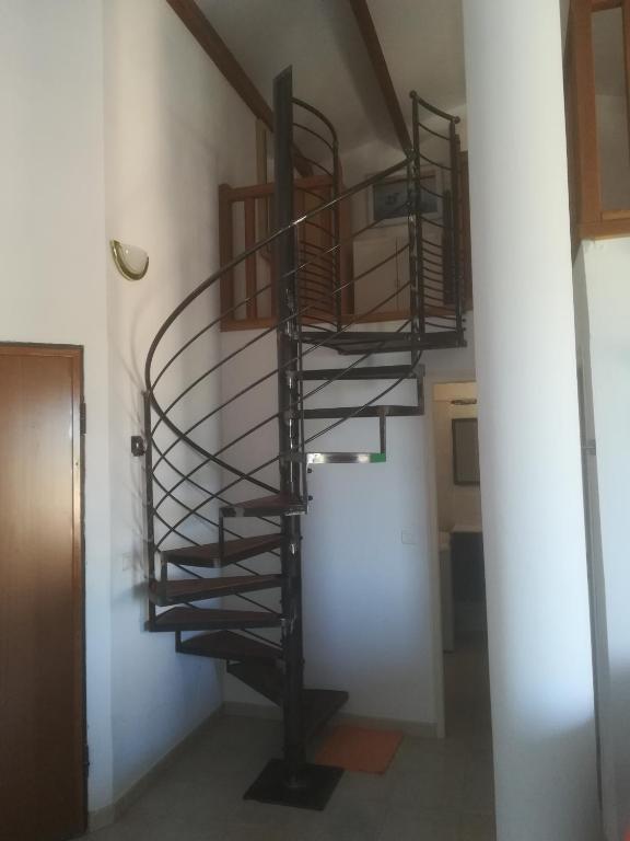 a spiral staircase in a room with a hallway at residence Mare Turchinu in Monticello