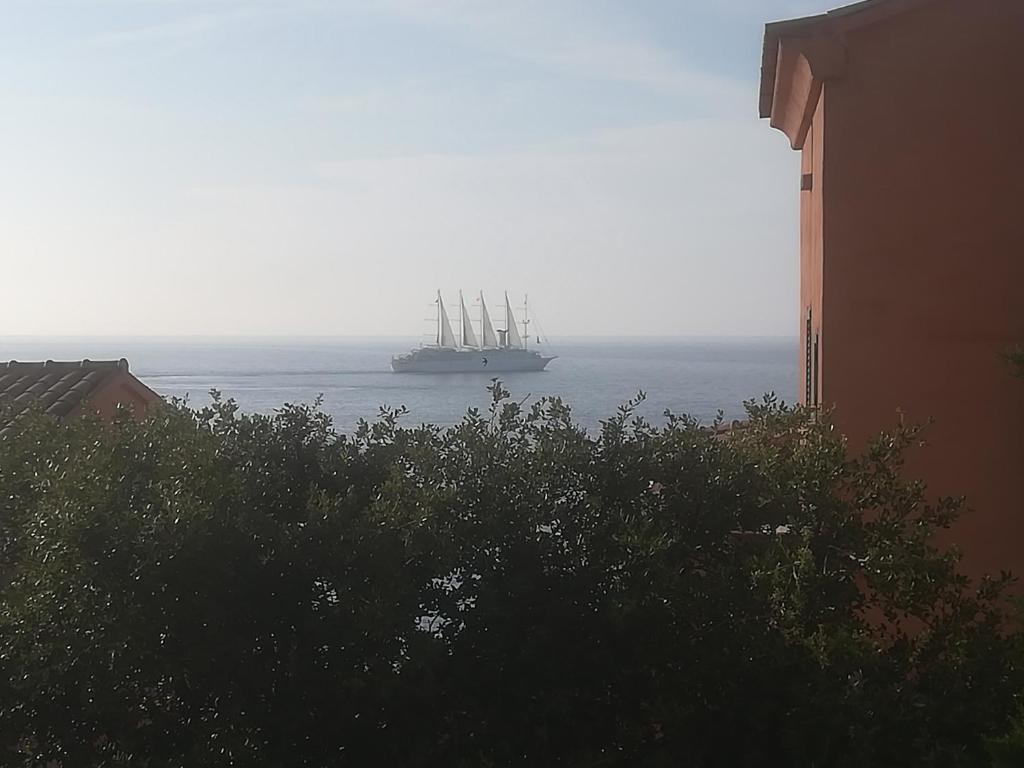 a large ship in the ocean with a building at residence Mare Turchinu in Monticello