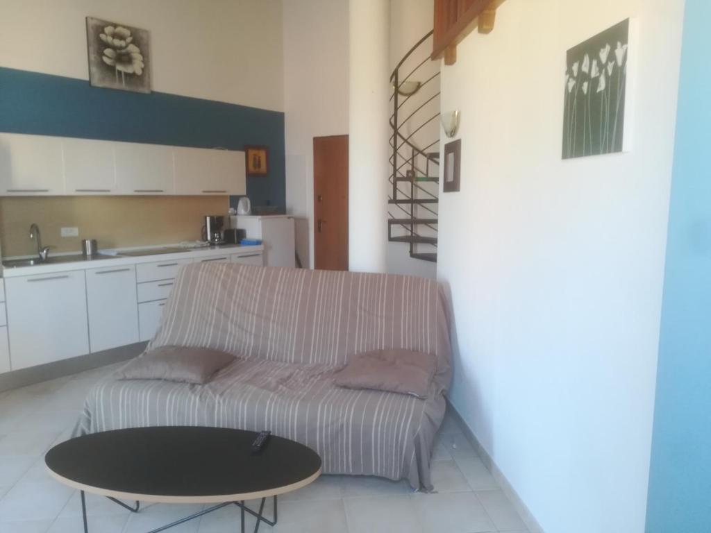 a living room with a couch and a table at residence Mare Turchinu in Monticello