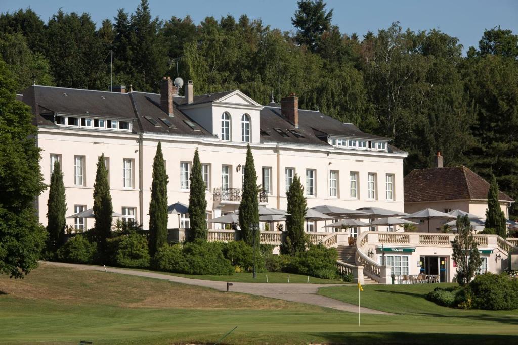 Fontenay-sur-LoingにあるDomaine et Golf de Vaugouard - La Maison Younanの緑の庭のある大きな白い邸宅