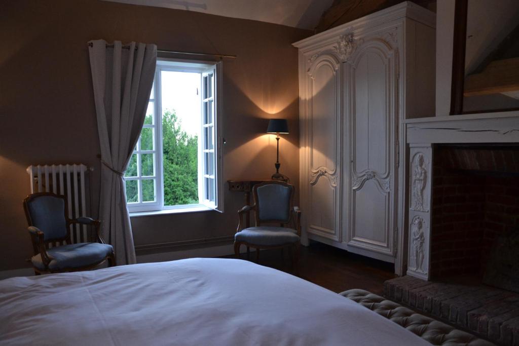Een bed of bedden in een kamer bij Les Hautes Sources - Esprit de France