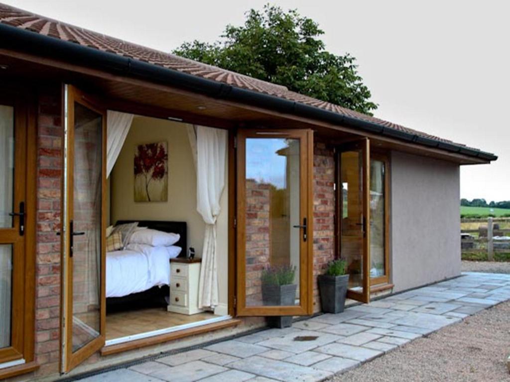 a room with a bed and sliding glass doors at Hillcroft Accommodation in Redhill