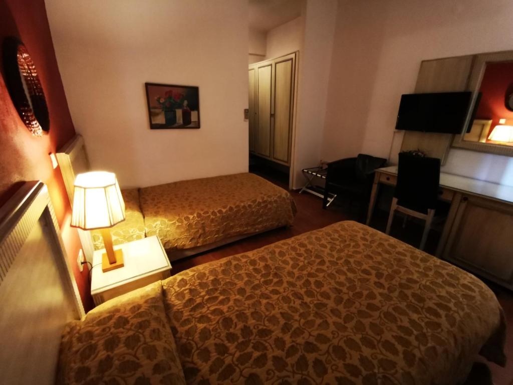 Łóżko lub łóżka w pokoju w obiekcie Hotel Electra