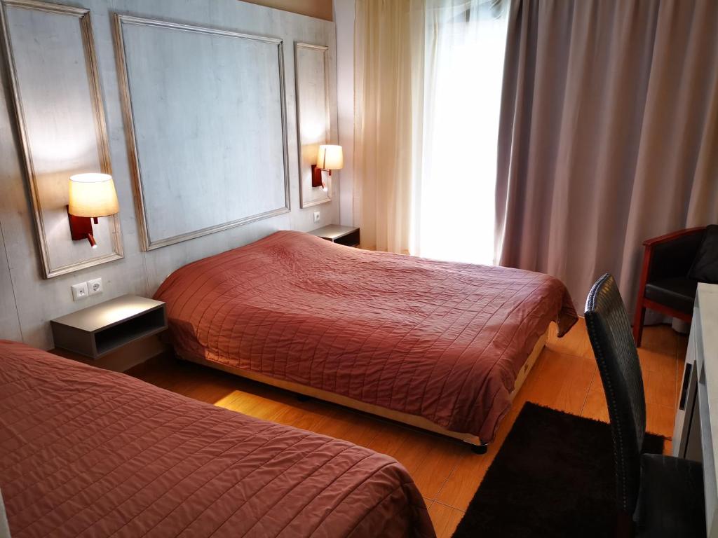 Łóżko lub łóżka w pokoju w obiekcie Hotel Electra