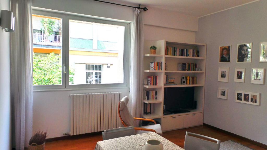 a living room with a window and a table and chairs at Vodice Flexyrent apartment in Milan