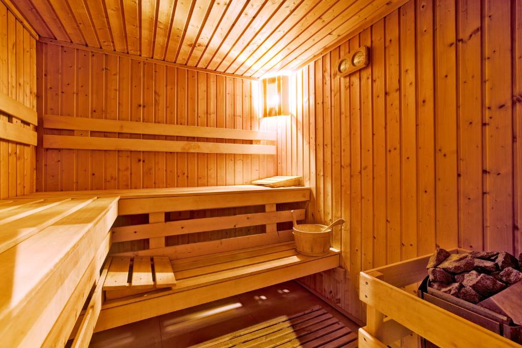 a wooden sauna with a bench in it at TUI MAGIC LIFE Penelope Beach - Families & Couples in Midoun