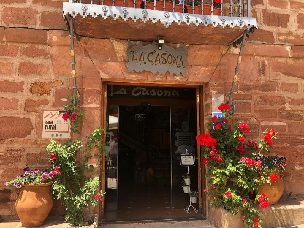 an entrance to a store with flowering plants and flowers at La Casona in Burgos
